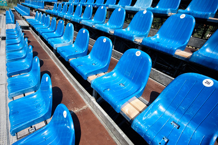 Empty and old plastic seats in the stadiumの写真素材