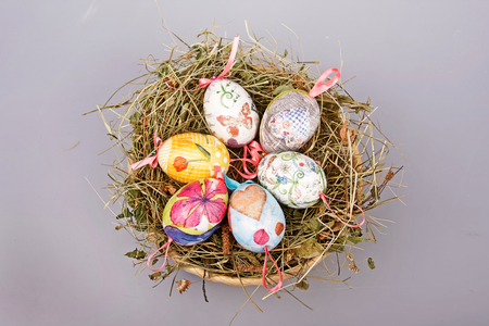 Close up of colorful Easter eggs in a basketの写真素材