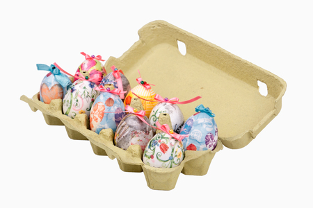 Colorful Easter eggs in egg box, isolated on whiteの写真素材