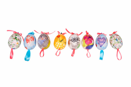 Colorful Easter decoupage eggs placed in line and isolated on white backgroundの写真素材