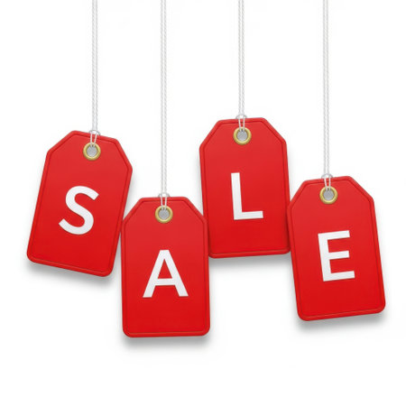 A group of four red, rectangular price tags, each with a hole and hanging from a white string, are arranged to spell the word SALE. The tags are slightly angled, creating a dynamic visual for promotions and advertising.の素材