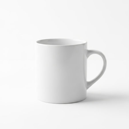 A simple, clean white ceramic mug with a comfortable handle, perfect for enjoying your favorite hot beverages like coffee, tea, or hot chocolate.の素材