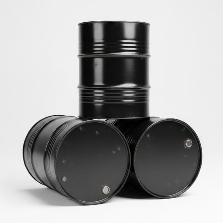 The image depicts three black barrels stacked in a triangular formation against a plain background. The barrels are cylindrical with ribbed sides and sealed lids, suggesting they are used for storage or transportation of liquids or solids. The barrels are positioned in such a way that the top one is slightly off-center, creating an interesting visual composition.の素材
