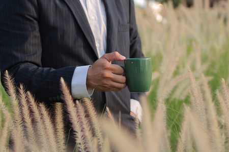 Happy business with reeds grass backgroundの写真素材