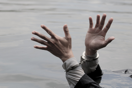 Businessman gets put his hands is drowning handful.の写真素材