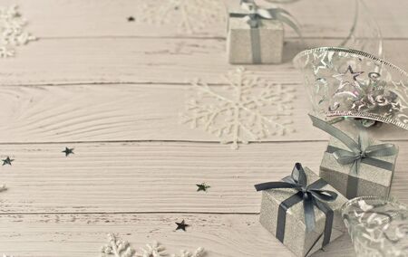 Background for New Year's greetings on a whitened wooden light background with festive silver...