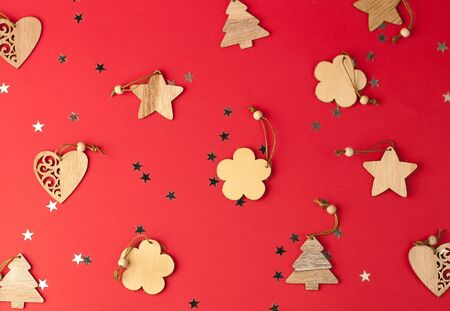 Christmas festive red background, on which lies a group of Christmas tree decorations, silver bows at the same distance from each otherの写真素材