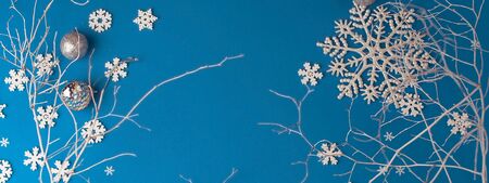 Christmas festive blue background, with a beautiful pattern of white snowflakes with a white painted...