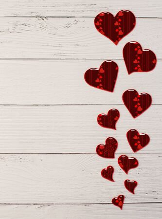 Holiday background for Valentine's Day on a white wooden background with felt carved hearts with place for text.の写真素材