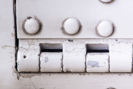 White steel wall with bolts, metal parts connection.の写真素材