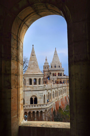 View on the numerous towers of Fisherman's Bastion on a winter day through an arch window. Budapest.の写真素材