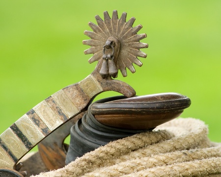Spur resting on a saddle horn wrapped with ropeの写真素材