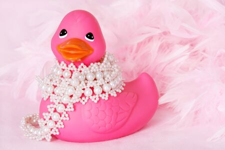 Pink rubber duck with pearls and feathersの写真素材