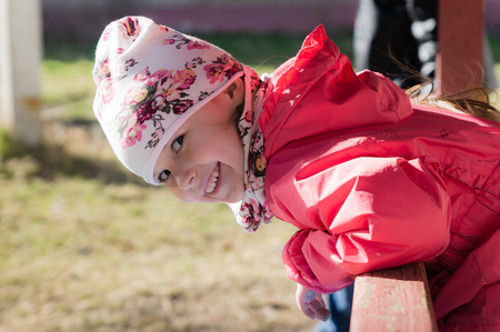 The little girl is smiling and looking at the camera.の写真素材