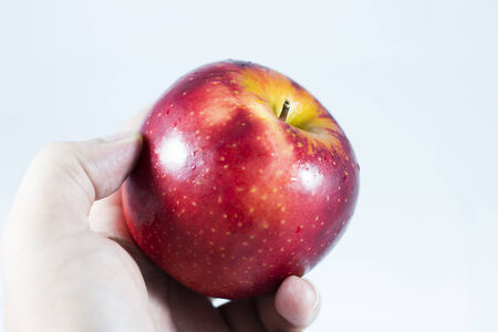 The apple on human hand with white background 