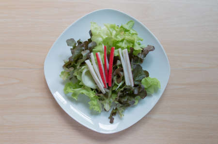Fresh healthy salad on wooden table. View from above.の写真素材