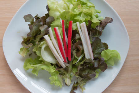 Fresh healthy salad on wooden table. View from above.の写真素材