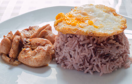 Rice with chicken and pork fried with garlic and pepperの写真素材