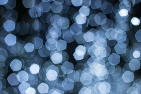 White bokeh background on black color.