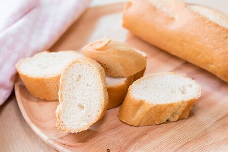 Sliced french bread baguette on wooden plate.Soft focus styleの写真素材
