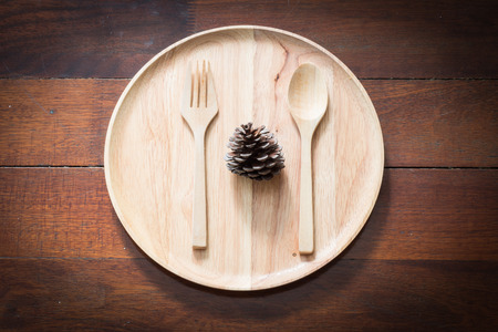 Vintage empty wood plate with spoon and frok.