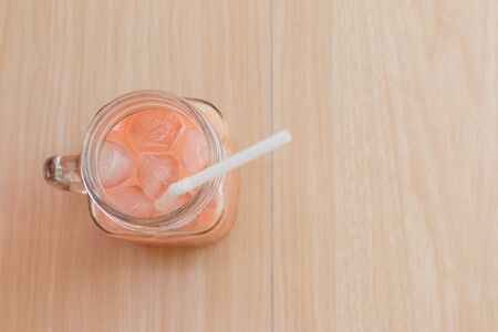 Ice milk tea from above on wood table,Thai milk tea.の写真素材