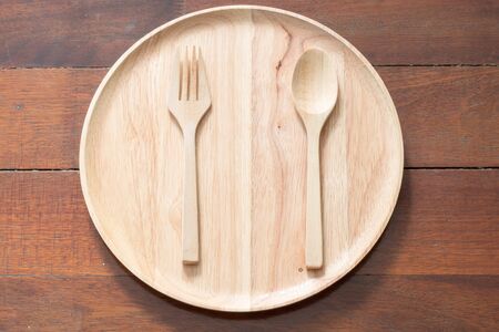 Empty wood dish with wood fork and wood spoonの写真素材