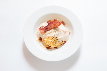 Bacon spaghetti on white background.の写真素材