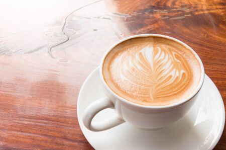 Hot coffee with flower from milk foam.の写真素材
