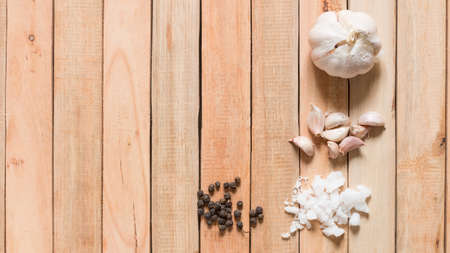 Bunch of fresh of fresh organic herbs with salt and garlic on wooden table, rustic style,Top view with copy spaceの写真素材