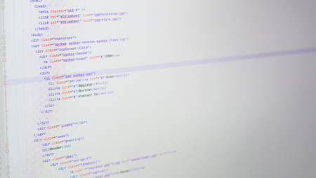 Web coding on developer computer screen.
