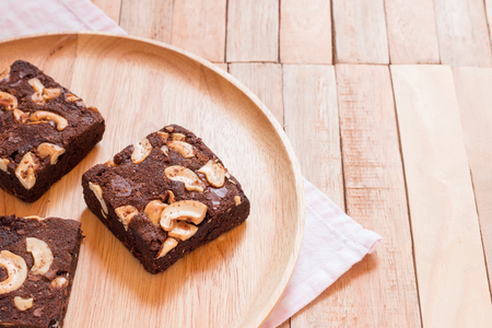 Chocolate brownie cake served on wooden plate.の写真素材