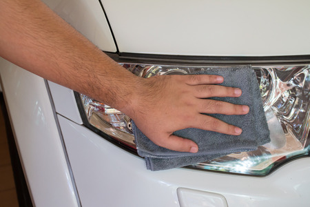Cleaning car with microfiber cloth by a man's hand.の写真素材