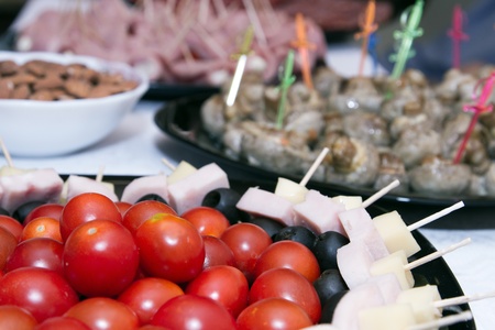 Cold snacks on the table   cherry tomatoes, canapes and meat snacksの写真素材