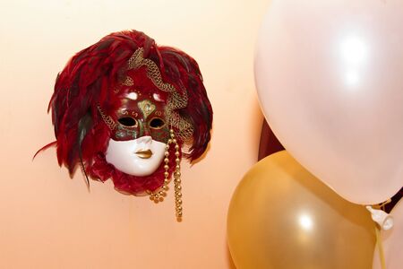 mask and balloon on the wallの写真素材