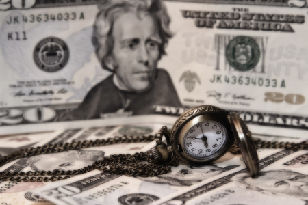 pocket watch lie on dollarsの写真素材