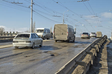 VOLGOGRAD - FEBRUARY 22  Cars are forced to bypass the pits on the road and tram ways  February 22, 2014 in Volgograd, Russia のeditorial素材