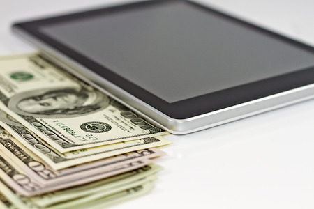  tablet-PC and dollars on white backgroundの写真素材