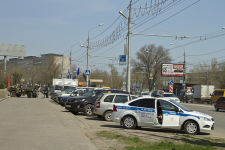  VOLGOGRAD - APRIL 21 Road patrol service of the new police car parked at the curb  April 21, 2014 in Volgograd, Russia In background tourists who came on Mamayev Kurgan photographed in a car wartimeのeditorial素材
