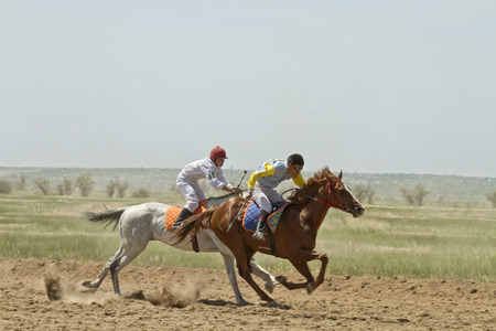 SMALL CHAPURNIKI, VOLGOGRAD, RUSSIA - MAY 24 The fight for the leading position in the race horses during the horse races devoted to celebration of the Sabantuy   May 24, 2014 in Volgograd, Russia のeditorial素材