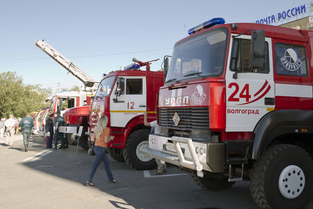 VOLGOGRAD - SEPTEMBER 6: Fire engines at the exhibition stand under the open sky on the background of the Central train station. . September 6, 2014 in Volgograd, Russia.のeditorial素材