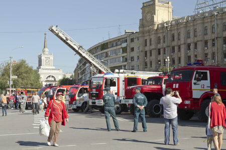 VOLGOGRAD - SEPTEMBER 6: Fire engines at the exhibition stand under the open sky on the background of the Central train station. . September 6, 2014 in Volgograd, Russia.のeditorial素材