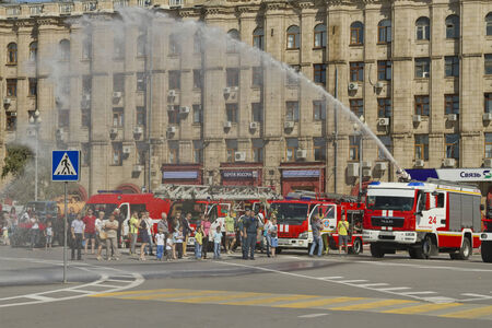 VOLGOGRAD - SEPTEMBER 6: Fire engines at the exhibition under the open sky demonstrate the possibility of a fire hose. September 6,water jet 2014 in Volgograd, Russia.のeditorial素材
