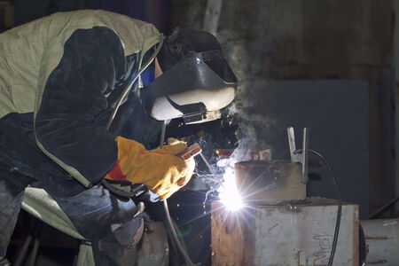 Welder working on welding of shells heat exchangerの写真素材