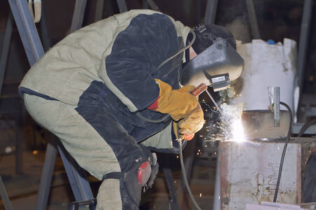 Welder working on welding of shells heat exchangerの写真素材