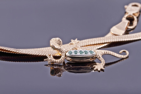 Unusual gold pendant in the form of a lizardの写真素材