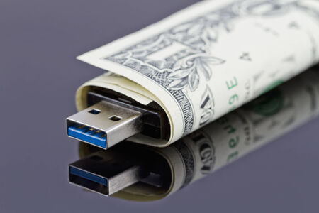Portable USB flash drive is wrapped in a dollarの写真素材