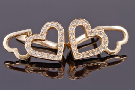 gold jewelry in the shape of heartsの写真素材