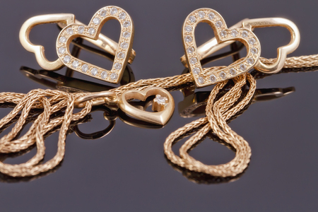 gold jewelry in the shape of heartsの写真素材