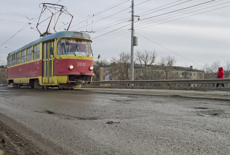 VOLGOGRAD - FEBRUARY 07: The tram climbs onto the bridge. The road surface at the rail in need of repair.. February 07, 2015 in Volgograd, Russia.のeditorial素材